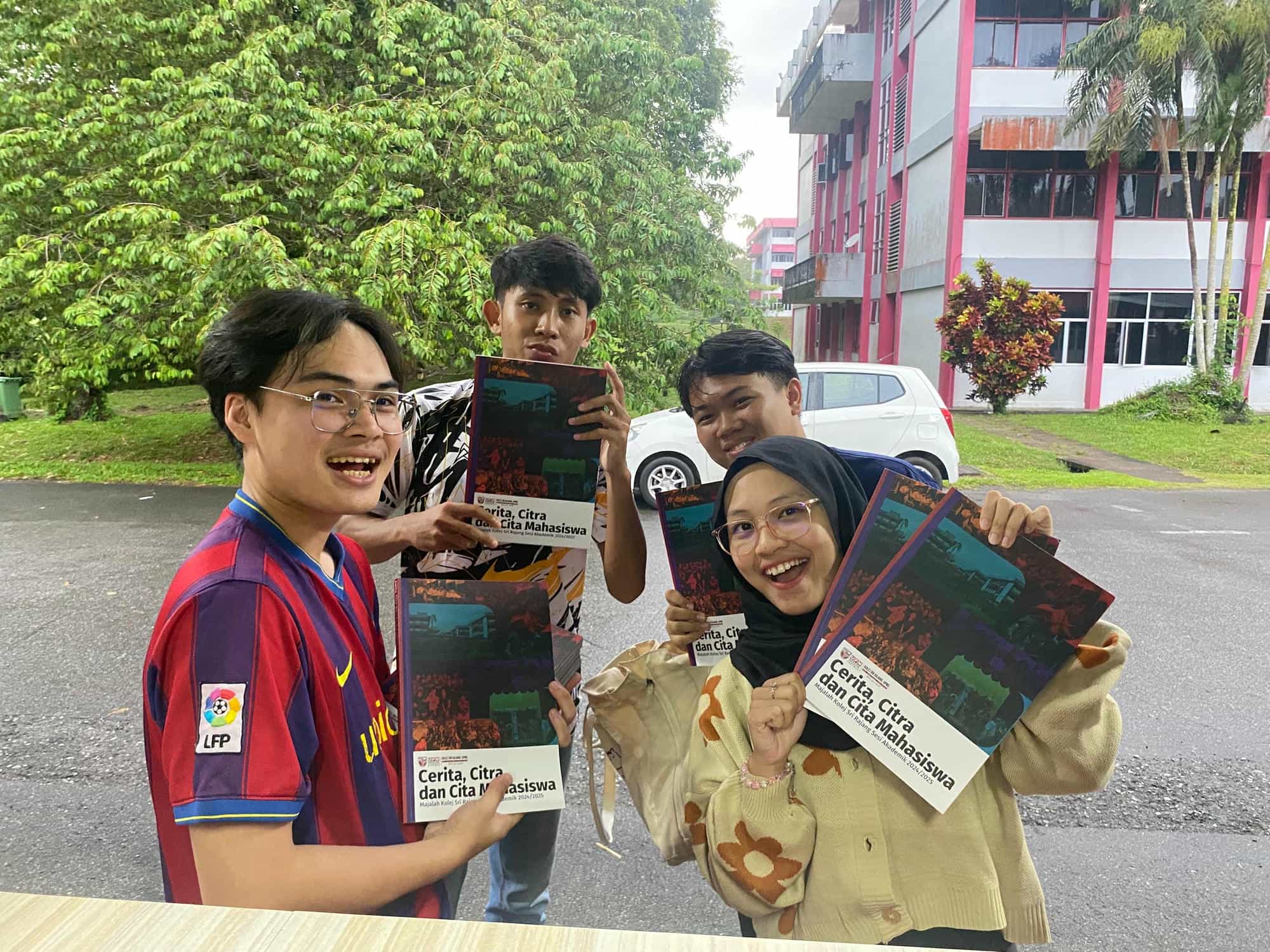 A group of people posing with the college magazine