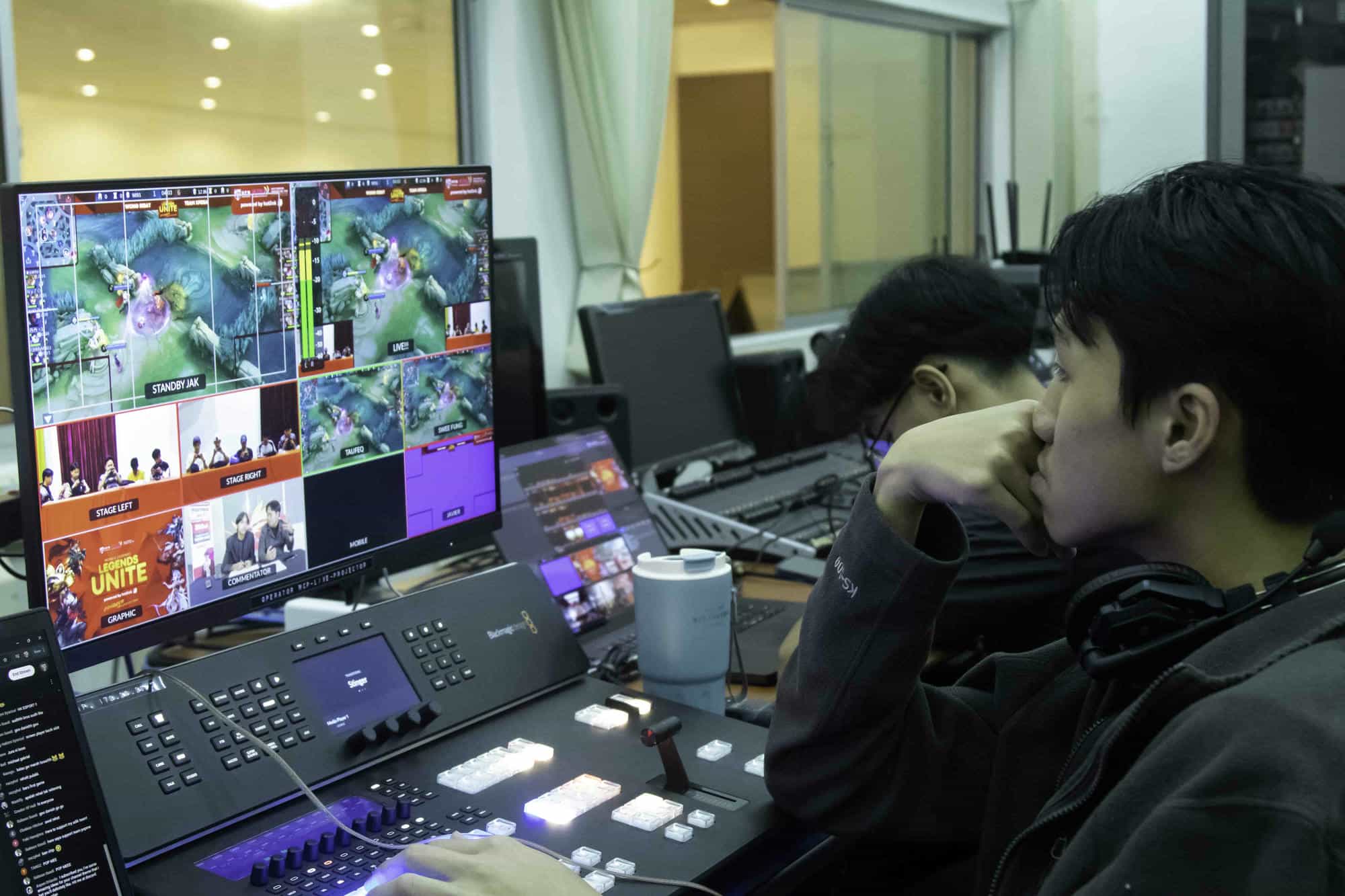 A person looking at a broadcast multiviewer screen